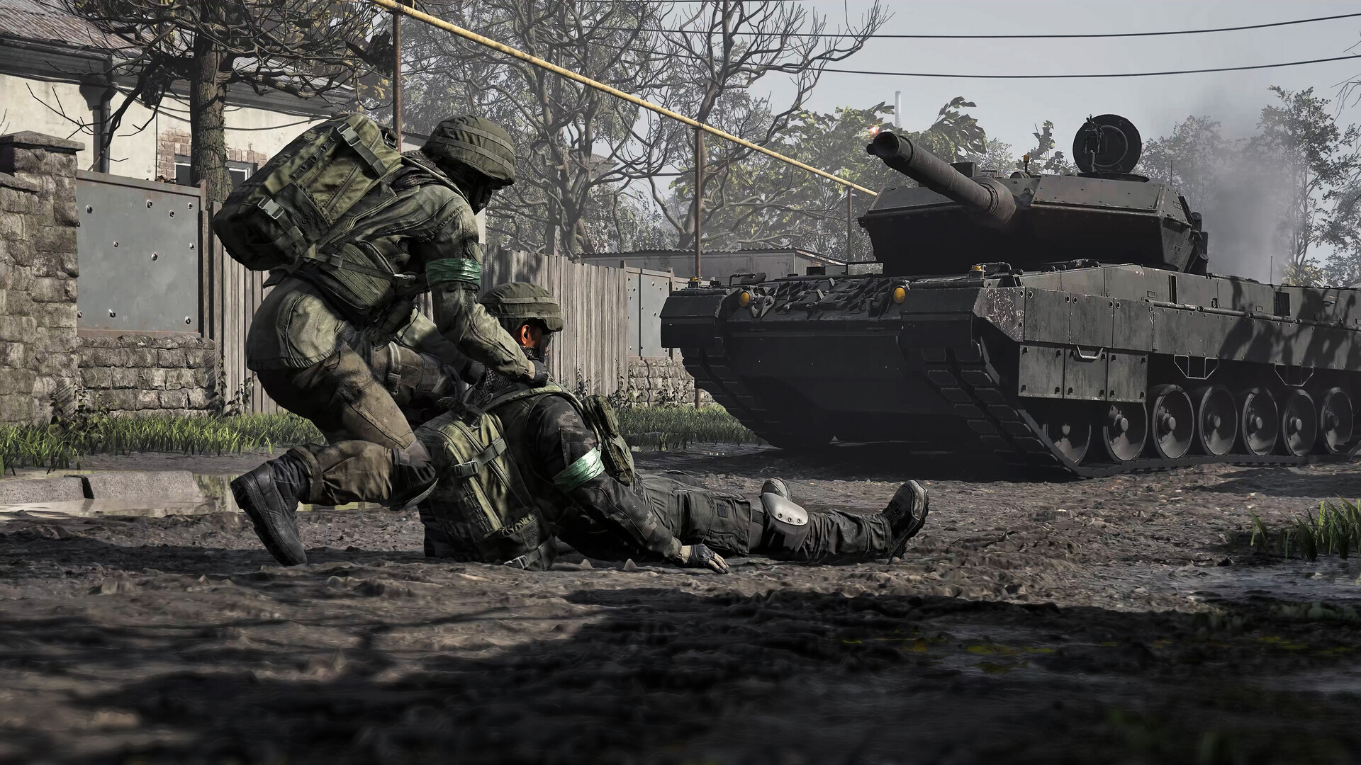 A WARDOGS soldier helps a teammate beside an armoured vehicle